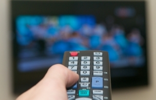 Holding remote pointed at television