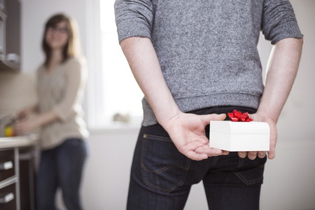 Man standing an holding a white gift box behind his back narcissists gifts