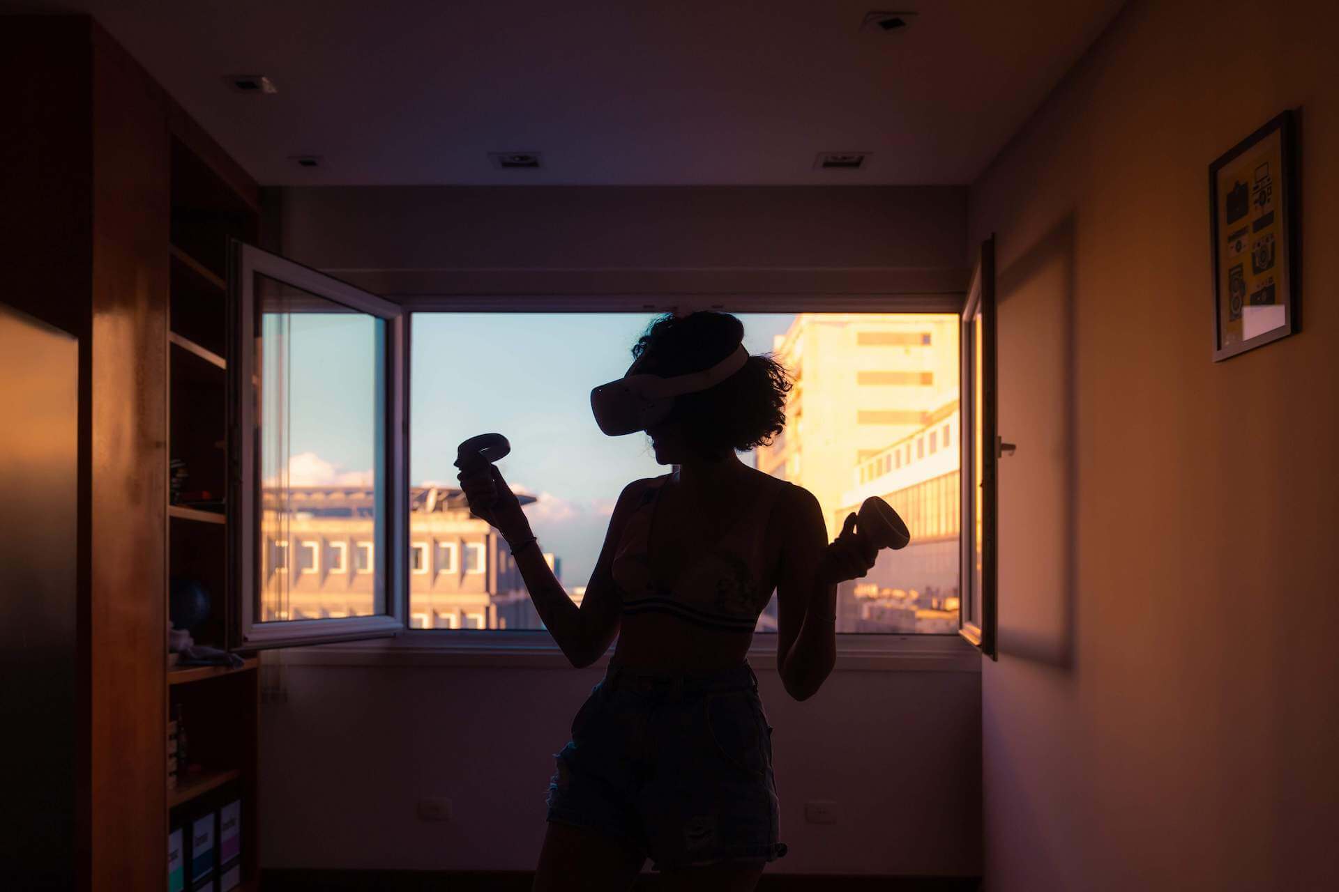 picture of a silhouette of a person using a virtual reality headset in front of a window- for Stephanie Sarkis blog post from Psychology Today