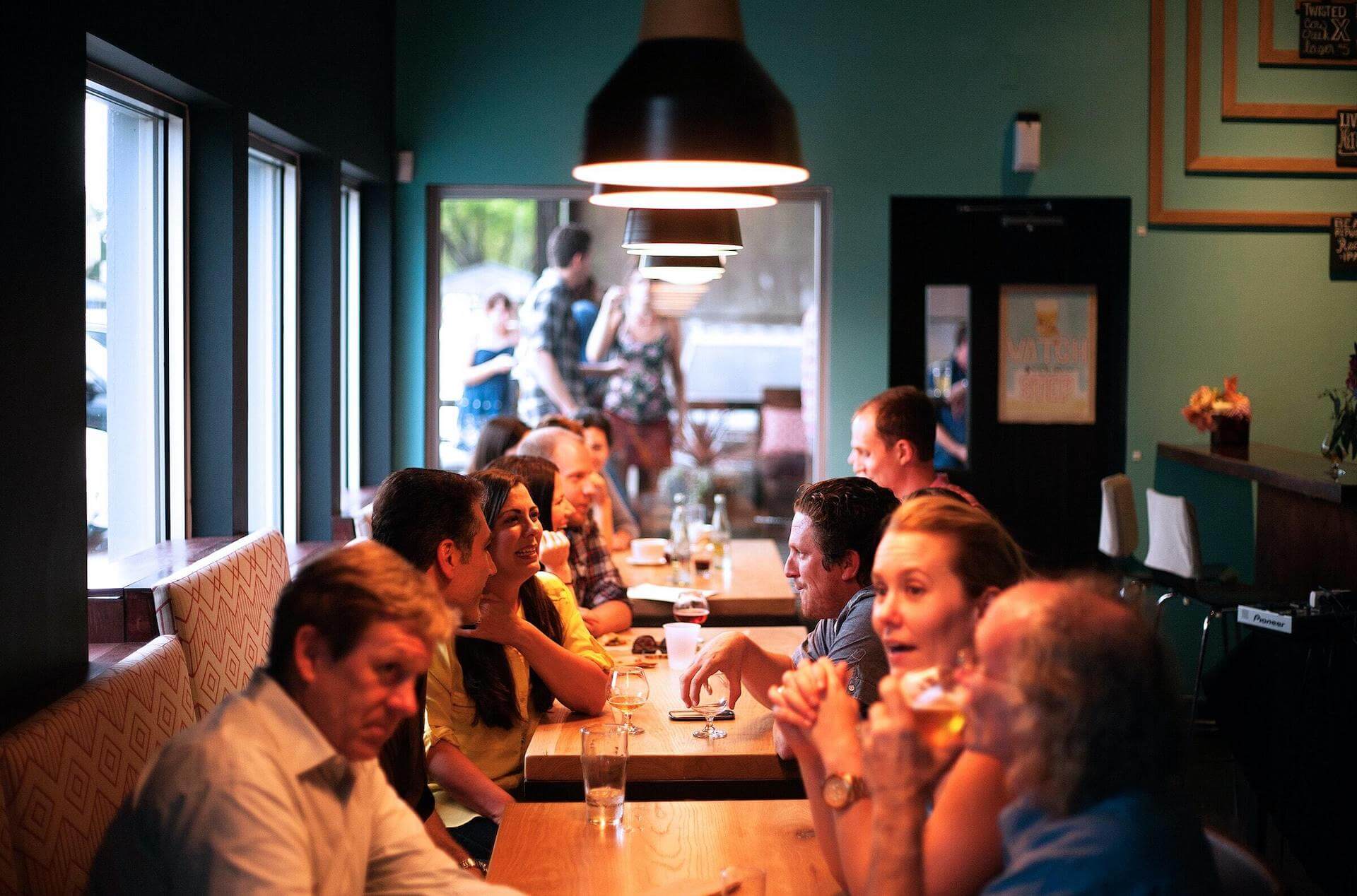 picture of people seated at restaurant tables for Stephanie Sarkis blog post on Psychology Today