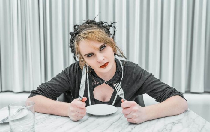 Stephanie Sarkis on Psychology Today. How to Handle a Covert Narcissist During Family Gatherings . Photo of a woman who appears angry with a fork and knife in hand. Photo credit: Bruce Mars, Unsplash